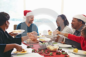 Multi Generation Family Enjoying Christmas Meal At Home