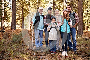 Multi generation family on forest hike, full length portrait