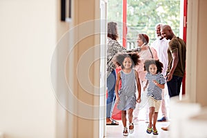 Multi Generation Family With Grandparents Visiting Grandchildren At Home