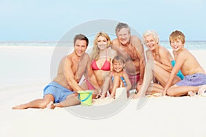 Multi Generation Family Having Fun On Beach Holiday