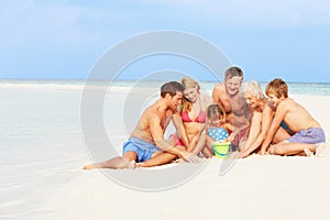 Multi Generation Family Having Fun On Beach Holiday