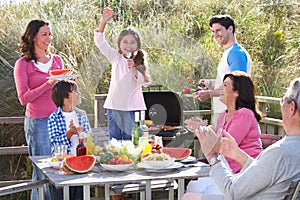 Multi Generation Family Having Outdoor Barbeque