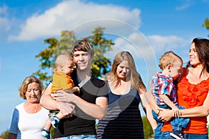 Multi-generation family on meadow in summer