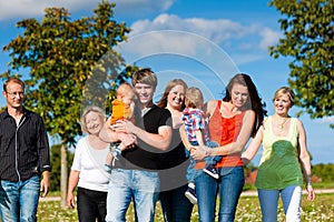 Multi-generation family on meadow in summer