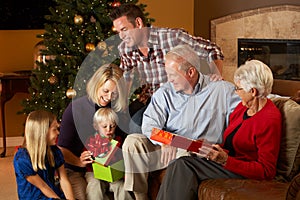 Multi Generation Family Opening Christmas Presents