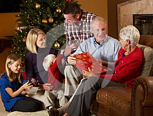 Multi Generation Family Opening Christmas Presents