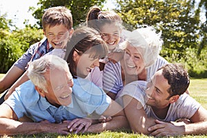 Multi Generation Family Piled Up In Garden Together photo