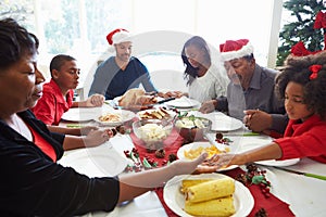 Multi Generation Family Praying Before Christmas Meal