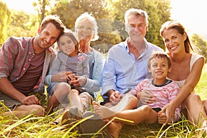 Multi-generation family relaxing together outdoors