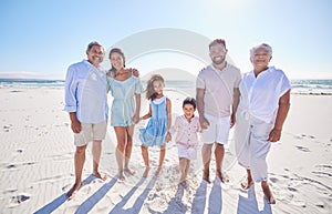 Multi generation family standing together at the beach. Mixed race family with two children, two parents and