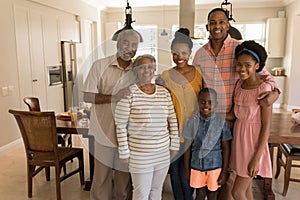 Multi-generation family standing together at home