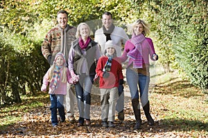 Multi-generation family on walk through woods