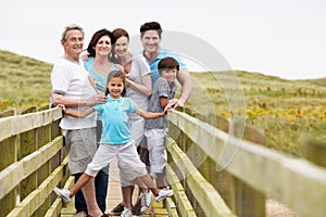 Multi Generation Family Walking Along Wooden Bridge photo