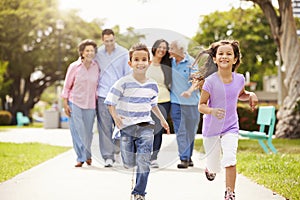 Multi Generation Family Walking In Park Together photo