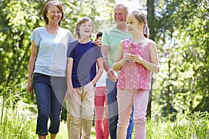Multi Generation Family Walking Through Summer Countryside