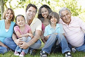 Multi Generation Hispanic Family Standing In Park photo