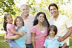 Multi Generation Hispanic Family Walking In Park photo