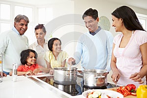 Multi Generation Indian Family Cooking Meal At Home