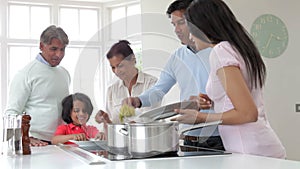 Multi Generation Indian Family Cooking Meal At Home