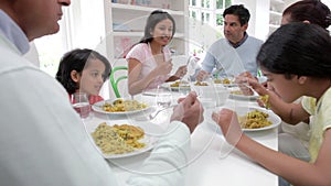 Multi Generation Indian Family Eating Meal At Home