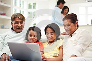 Multi-Generation Indian Family With Laptop