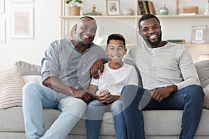 Multi generation male family members posing together at home