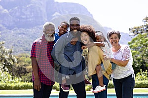 Multi-generation mixed race family enjoying their time at a garden