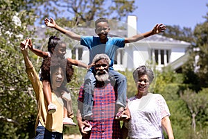 Multi-generation mixed race family enjoying their time at a garden