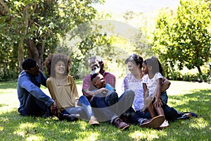 Multi-generation mixed race family enjoying their time at a garden