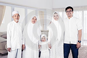 Multi-generation muslim family portrait at home