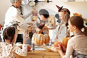 Multi generational family making jack o lantern photo