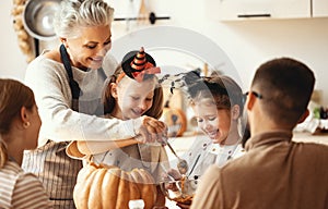 Multi generational family preparing for Halloween in kitchen