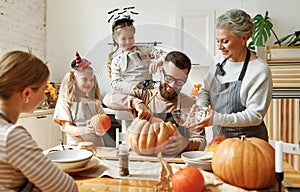 Multi generational family preparing for Halloween in kitchen