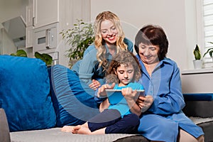 Multi-generational learning concept, senior woman learning how to use modern electronics