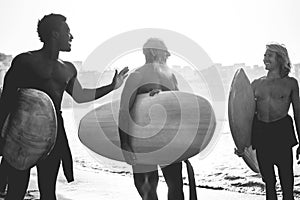 Multi generational surfer men having fun on the beach - Focus on silhouettes