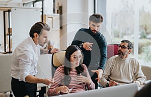 Multi generational team of business employees engaged in a creative business discussion.