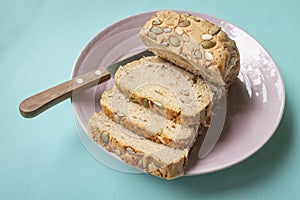 Multi-Grain Bread slice with knife on ceramic plate