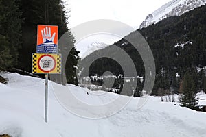 multi language signs indicating road closure due risk of avalanches