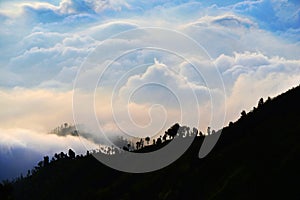 Multi layer of cloud behind mountain during sunset