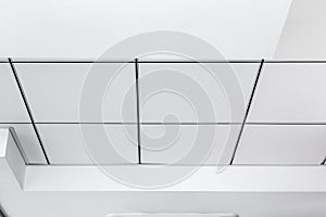 Multi-level ceiling with three-dimensional protrusions and a suspended tiled ceiling.