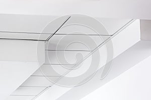 Multi-level ceiling with three-dimensional protrusions and a suspended tiled ceiling.