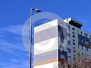 Multi level horizontally striped bright stucco finished apartment building