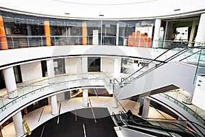 Multi-level modern light interior in a shopping center with an escalator. view from above