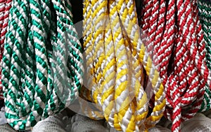 Multi-purpose ropes of different colors on the shop window. Synthetic cord.