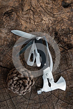 Multi purpose tool on rustic wooden table ,camping and survival tools for every day