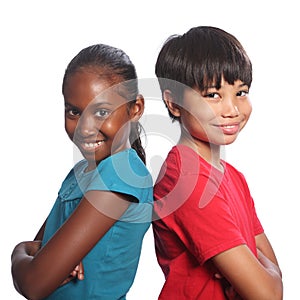 Multi-racial boy and girl back to back arms folded