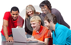 Multi-racial college students around a computer