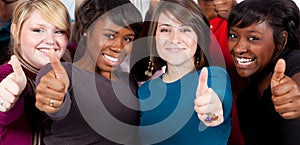 Multi-racial college students with thumbs up