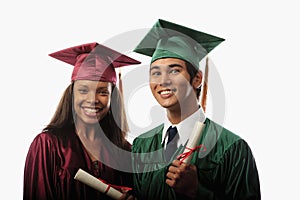 Multi racial couple in cap and gown