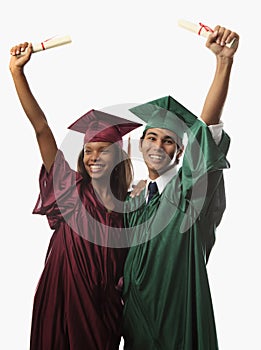 Multi racial couple in cap and gown